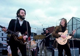 The Beatles perform on the roof of the Apple building.